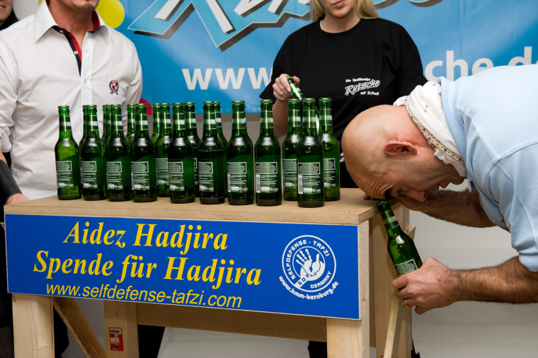 The most bottle caps removed with the head in one minute is 24, achieved by Ahmed Tafzi (Germany) in Hamburg, Germany, on 16 November 2011, in celebration of Guinness World Records Day.
Credit: Alexander Pihuliak/Guinness World Records